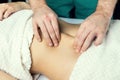 Hands of a masseur`s man doing a massage of the abdomen Royalty Free Stock Photo