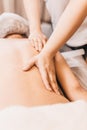 Hands of a masseuse on a female back during work - massage salon Royalty Free Stock Photo