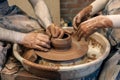 hands of a master potter and a child making dishes. A lesson in a pottery workshop. hands of a potter, creating an Royalty Free Stock Photo