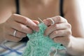 Hands of a master seamstress at work, knitting.