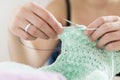 Hands of a master seamstress at work, knitting.