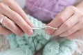 Hands of a master seamstress at work, knitting.