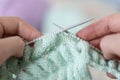 Hands of a master seamstress at work, knitting.