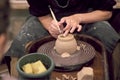 The hands of the master working with clay on a potter`s wheel, close-up Royalty Free Stock Photo