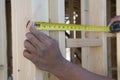 Hands Measuring Between Boards With Tape Measure At Site Royalty Free Stock Photo