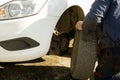 Hands of mechanic changing car wheel in auto repair service Royalty Free Stock Photo