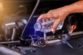 Hands of mechanic check water in car radiator and add water to car radiator, service and maintenance of cars or vehicles, Royalty Free Stock Photo