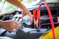 Hands of mechanic check water in yellow car radiator and add water to car radiator Royalty Free Stock Photo