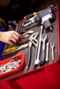 Hands, mechanic and toolbox for auto service at workshop, small business or garage. Closeup, man and equipment, toolkit