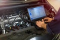Mechanic Using Laptop While Examining Car Engine Royalty Free Stock Photo