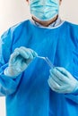 Hands of medical staff with a nasal sample on a swab and a test tube Royalty Free Stock Photo