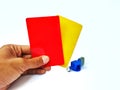 The hands of men brandishing red cards and yellow cards on a white background Royalty Free Stock Photo