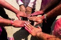 Hands of men painted with colorful powder at Hindu celebration party