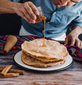 Hands of mexican man pouring honey on mexican buÃÂ±uelos, recipe and ingredients of traditional dessert for Christmas in Mexico. Royalty Free Stock Photo
