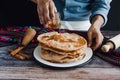 Hands of mexican man pouring honey on mexican buÃÂ±uelos, recipe and ingredients of traditional dessert for Christmas in Mexico. Royalty Free Stock Photo