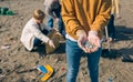 Hands with microplastics on the beach Royalty Free Stock Photo