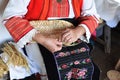 Hands of middle-aged woman osier-knitter craftswoman in Bulgarian folk costume