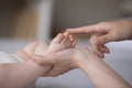 Hands of mom touching little baby tiny feet, caressing kid Royalty Free Stock Photo