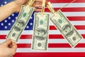 Hands and money laundering. USA Illegal financial business concept, American dollar banknotes hanging on a rope Royalty Free Stock Photo