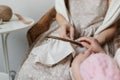 The hands of the mother and child embroidered close-up. Hoop and linen cloth in hand