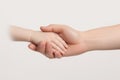 Hands of mother and child holding each other on a white background, A newborn baby and mother holding hands on a white background