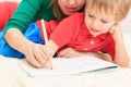 Hands of mother and child writing letters