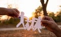 Hands of mother and daughter holding family cut out paper in autumn park on sunset background Royalty Free Stock Photo