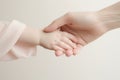 Hands of mother and daughter holding hands, isolated on white background, Newborn baby and mother holding hands on a white