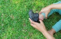 Hands of mother helping her baby to put shoes in the garden outdoor Royalty Free Stock Photo