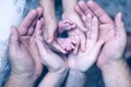 Hands of mother keep little feet baby. Friendly happy family Royalty Free Stock Photo