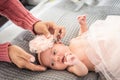 Hands of a mother placing a bow to a baby in pink ballet dress Royalty Free Stock Photo