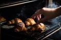 Hands of mother putting burnt croissants out of oven, created with Generative AI technology