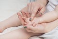 Hands of a mother and a small child, close-up, light colors. Mom hugs the baby. The concept of maternal Royalty Free Stock Photo