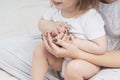 Hands of a mother and a small child, close-up, light colors. Mom hugs the baby. The concept of maternal Royalty Free Stock Photo