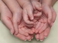 The hands of a mother and two children are folded together. The concept of Family, Parental Love, Happiness, Care, Responsibility Royalty Free Stock Photo