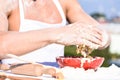 Hands of muscular baker or cook kneading dough in bowl. Hands of chef cook working with dough and flour. Bowl with dough