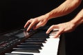 Hands of musician play the keys of the synth on black background Royalty Free Stock Photo