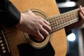 Hands of a musician playing an acoustic guitar with metal strings. Hobby. Musical instruments. Selective focus Royalty Free Stock Photo