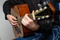 Hands of a musician playing an acoustic guitar with metal strings. Hobby. Musical instruments. Selective focus Royalty Free Stock Photo