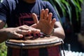 Hands of a musician playing the atabaque. Feeling of power and speed