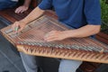 hands of musician playing on cimbalom or dulcimer,