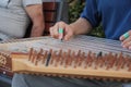 hands of musician playing on cimbalom or dulcimer,