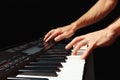 Hands of musician playing the digital piano on black background Royalty Free Stock Photo