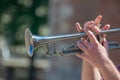 Hands of the musician playing a trumpet. close up musician with trombone on a public event Royalty Free Stock Photo