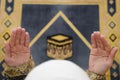 Hands of muslim woman on the carpet praying in traditional wearing clothes, Woman in Hijab, Carpet of Kaaba, Royalty Free Stock Photo
