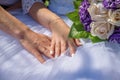 Hands of newly married couple with got on golden rings on wedding dress Royalty Free Stock Photo