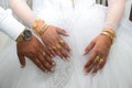 hands of newlyweds with gold jewelry and watches, wedding photo bride and groom Royalty Free Stock Photo