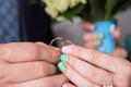 Hands of newlyweds holding gold wedding rings close-up. Concept of wedding and love Royalty Free Stock Photo