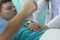 Hands nurse doing heart massage to man in clinic