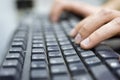 Hands of an office operator typing on dirty keyboard